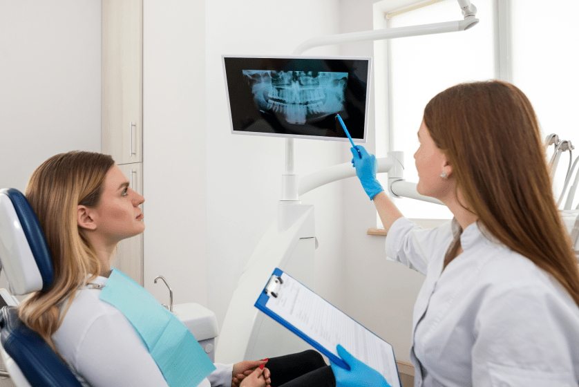 Dentist showing patient xray