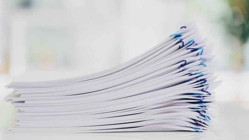 Stack of documents organized with paper clips in an office